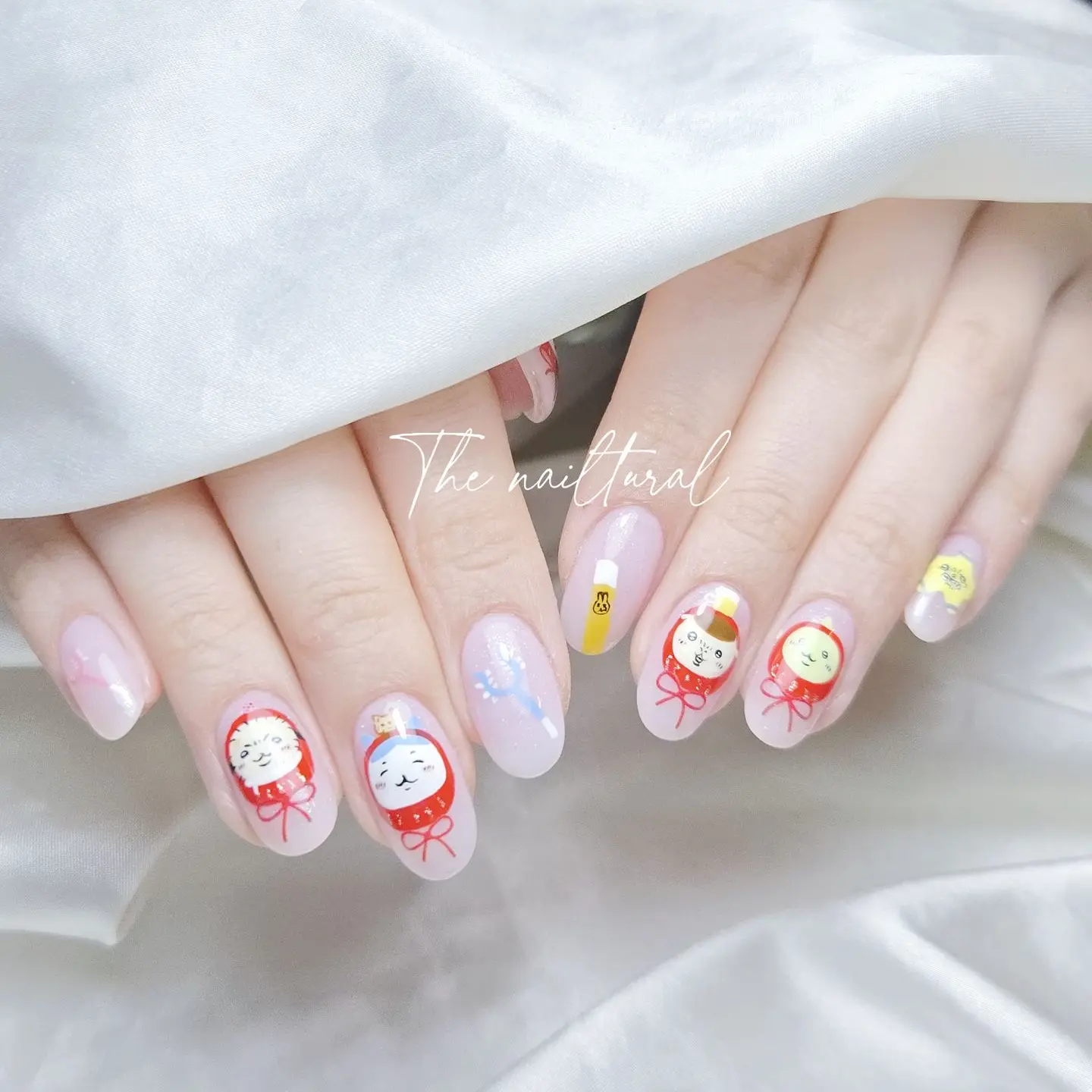 oval-shaped nails, whimsical,hand-painted Japanese Daruma doll designs,  Chiikawa nail art, 